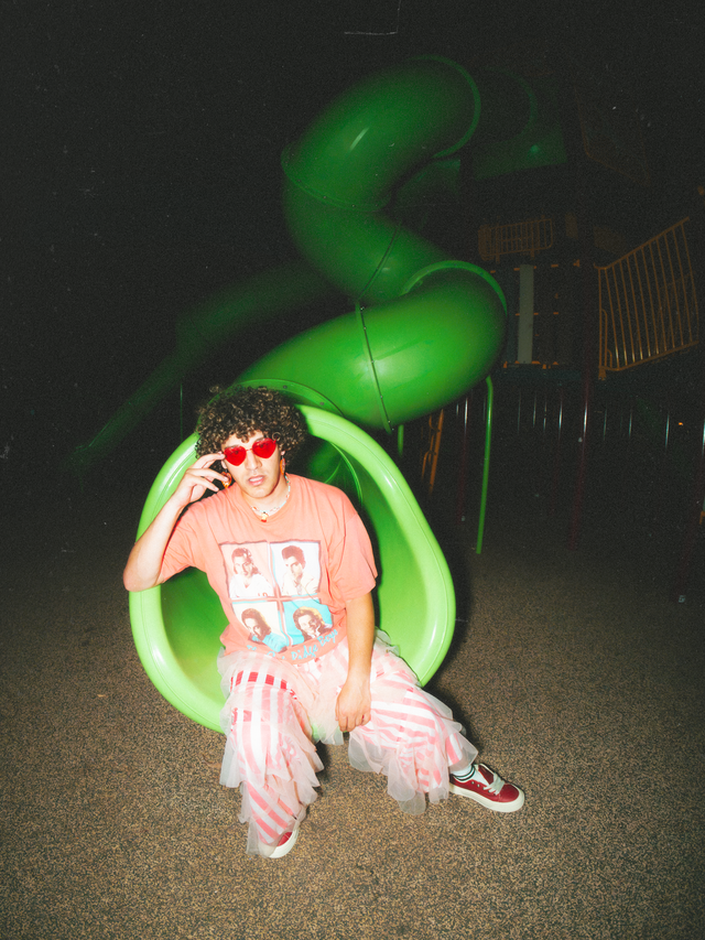 Dolo Tonight sitting in a green playground slide